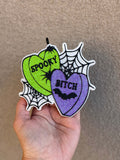 Spooky B Freshie air freshener with glittery green and purple heart designs, spiderweb accents and black lettering