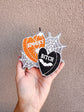 Spooky B Freshie in orange and black glitter hearts with white lettering, spiderweb accents, and bat detail