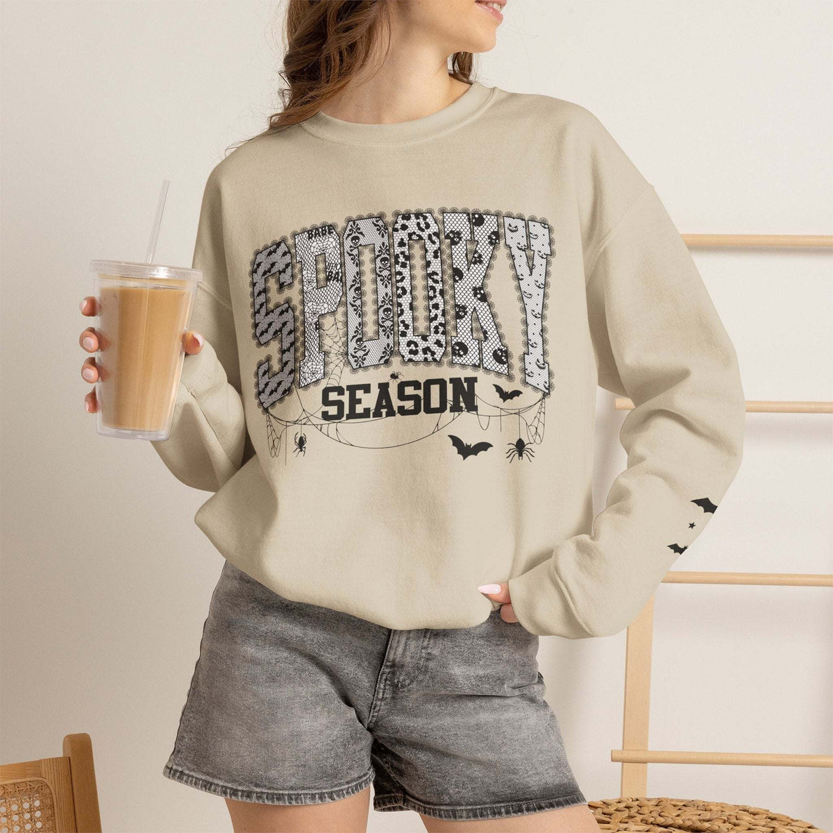 Unisex spooky season sweatshirt with Halloween bats and spiderweb graphics