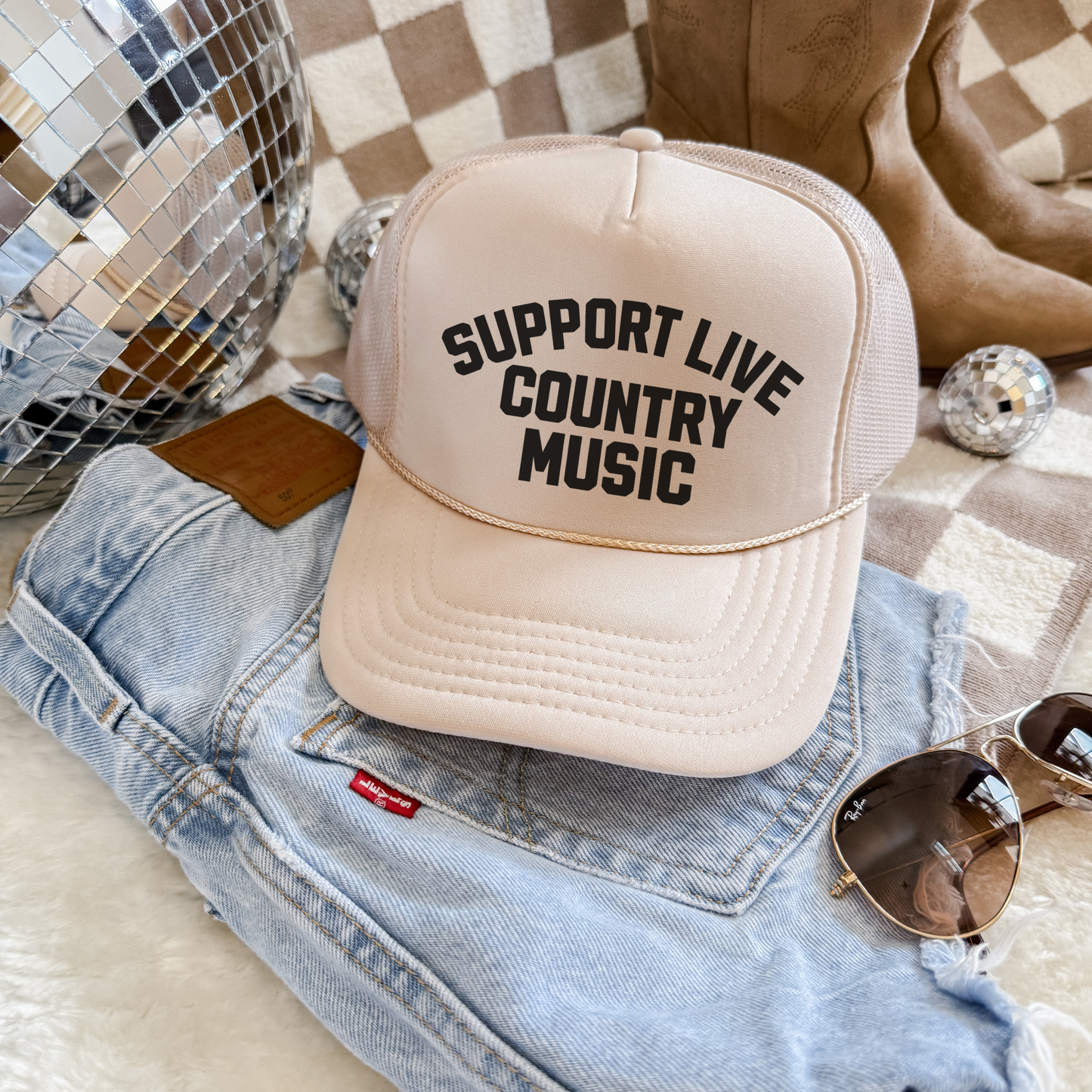 Support Live Country Music trucker hat in cream with bold black text, foam front and mesh back