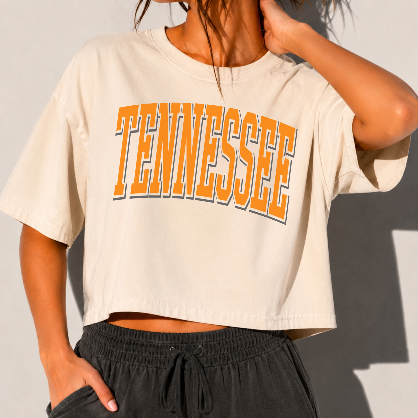 Tennessee pride boxy cropped graphic tee in ivory cotton with bold orange collegiate Tennessee lettering and crew neck