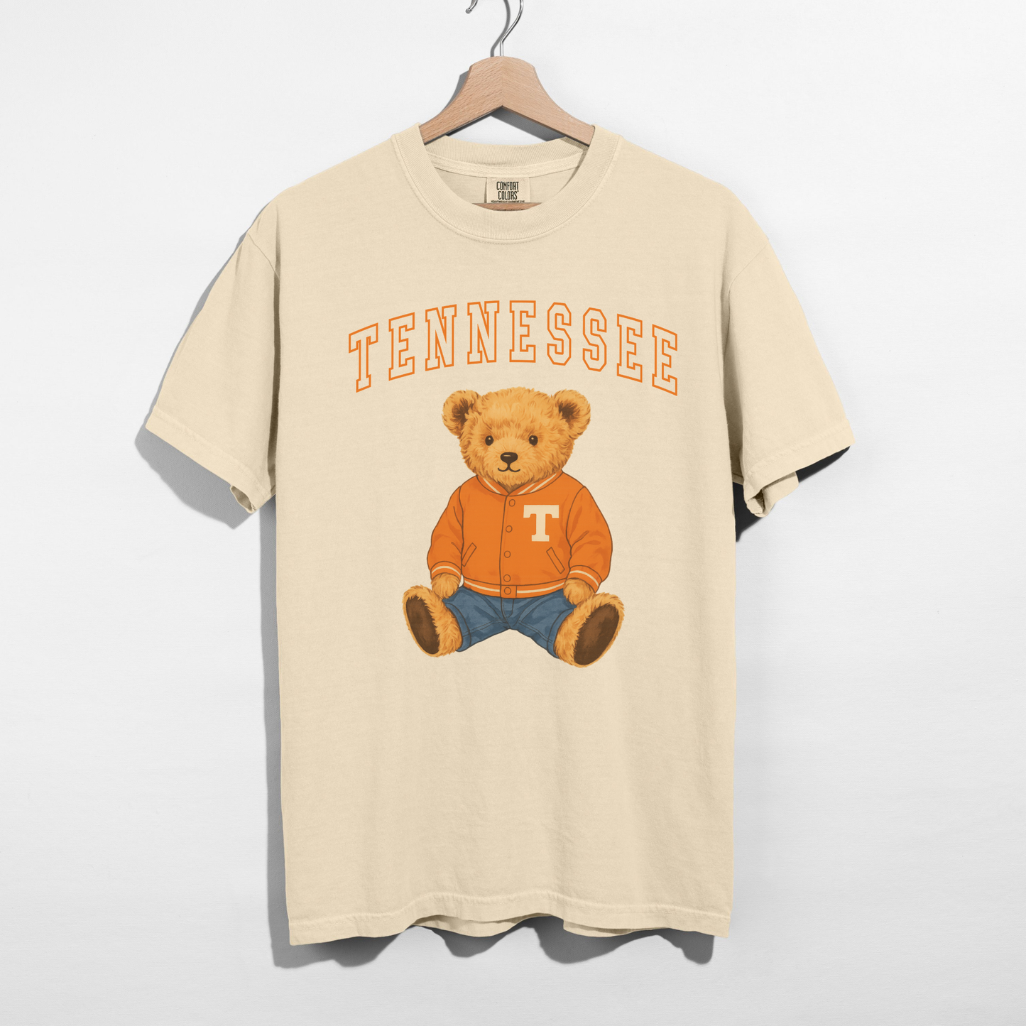 Tennessee Teddy Bear graphic tee in cream cotton with orange arched lettering and seated bear in an orange jacket