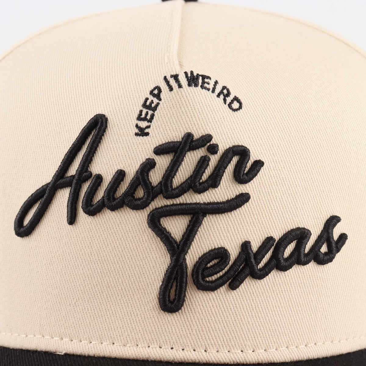 The "Austin" Script Hat in beige with black embroidered Austin Texas script and Keep It Weird lettering