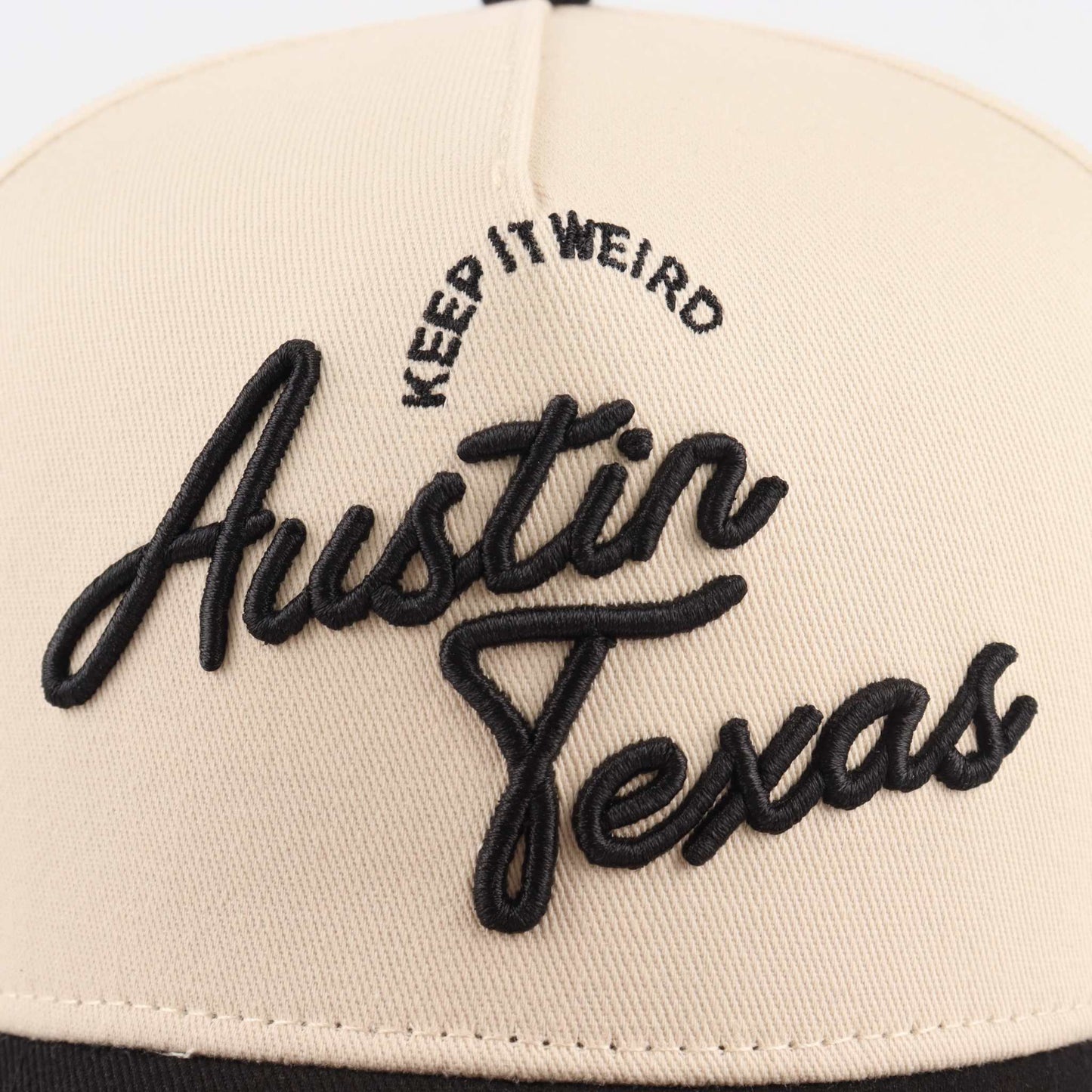 The "Austin" Script Hat in beige with black embroidered Austin Texas script and Keep It Weird lettering