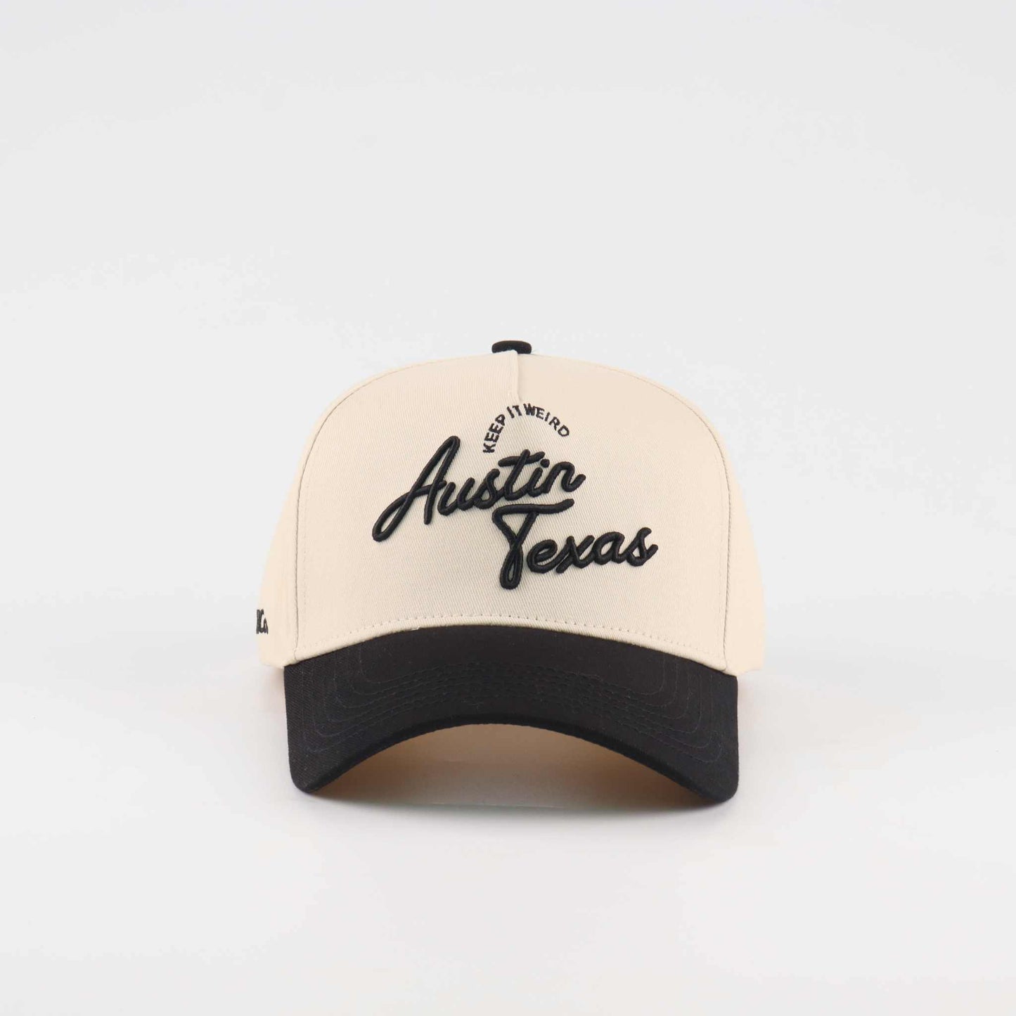 The "Austin" Script Hat, beige and black trucker cap with embroidered Austin Texas script and curved brim