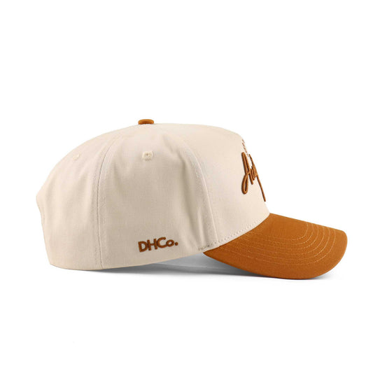 The Austin Script Hat, beige cotton cap with orange pre-curved brim and embroidered script logo
