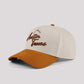 The Austin Script Hat, a beige and orange cotton cap with embroidered Austin Texas script and a pre-curved brim