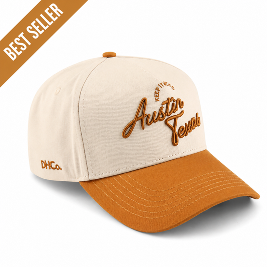 The Austin Script Hat, beige cotton cap with orange pre-curved brim and embroidered Austin Texas script

