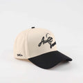 The "Austin" Script Hat, beige cotton trucker cap with black curved brim and embroidered Austin script lettering