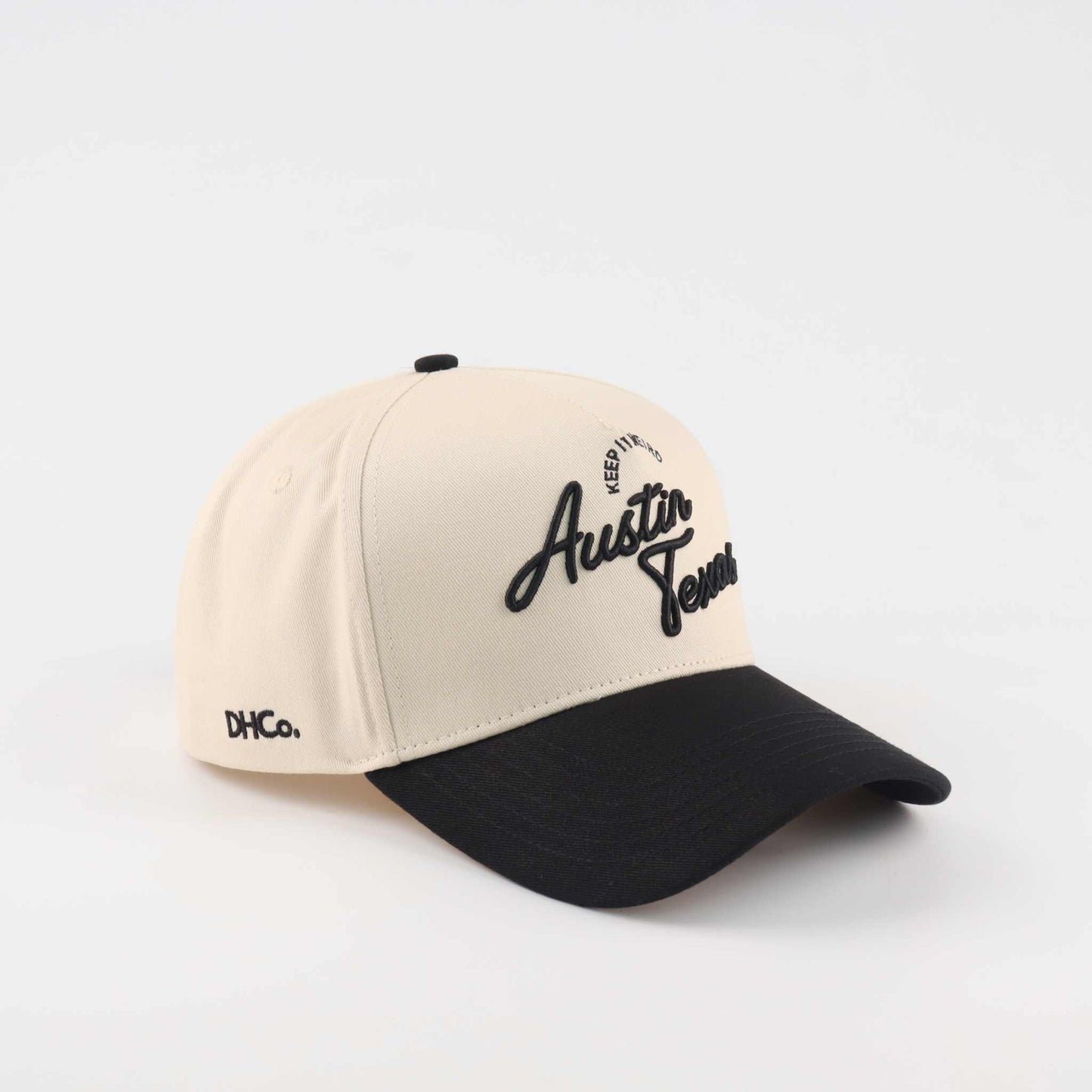 The "Austin" Script Hat, beige cotton trucker cap with black curved brim and embroidered Austin script lettering