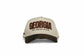 The Camo Georgia Snapback beige trucker hat with brown camouflage brim and embroidered Georgia peach state lettering