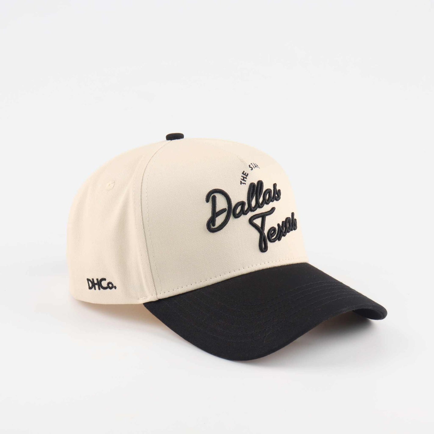 The Dallas Script Hat, beige and black pre-curved trucker cap with embroidered Dallas script and black brim