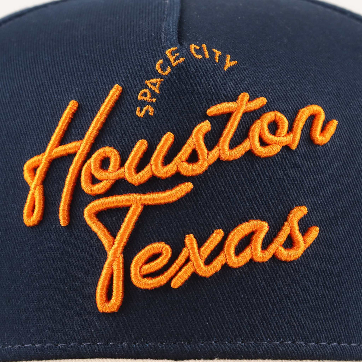 The "Houston" Script Hat in navy fabric with bright orange embroidered Houston Texas script and Space City text