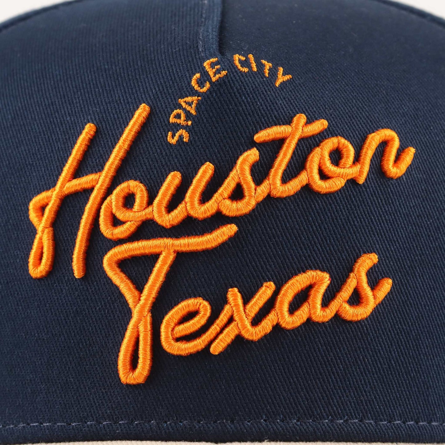 The "Houston" Script Hat in navy fabric with bright orange embroidered Houston Texas script and Space City text