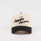 The Lafayette Script Hat, beige and black trucker cap with embroidered Lafayette Louisiana script and curved brim