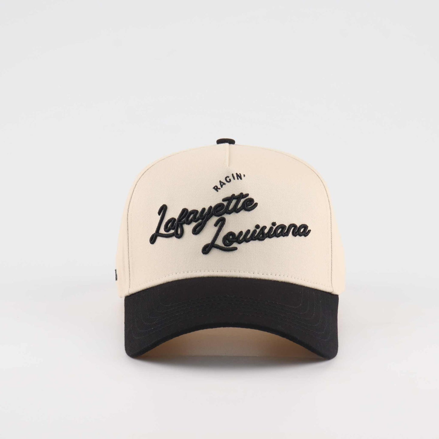 The Lafayette Script Hat, beige and black trucker cap with embroidered Lafayette Louisiana script and curved brim
