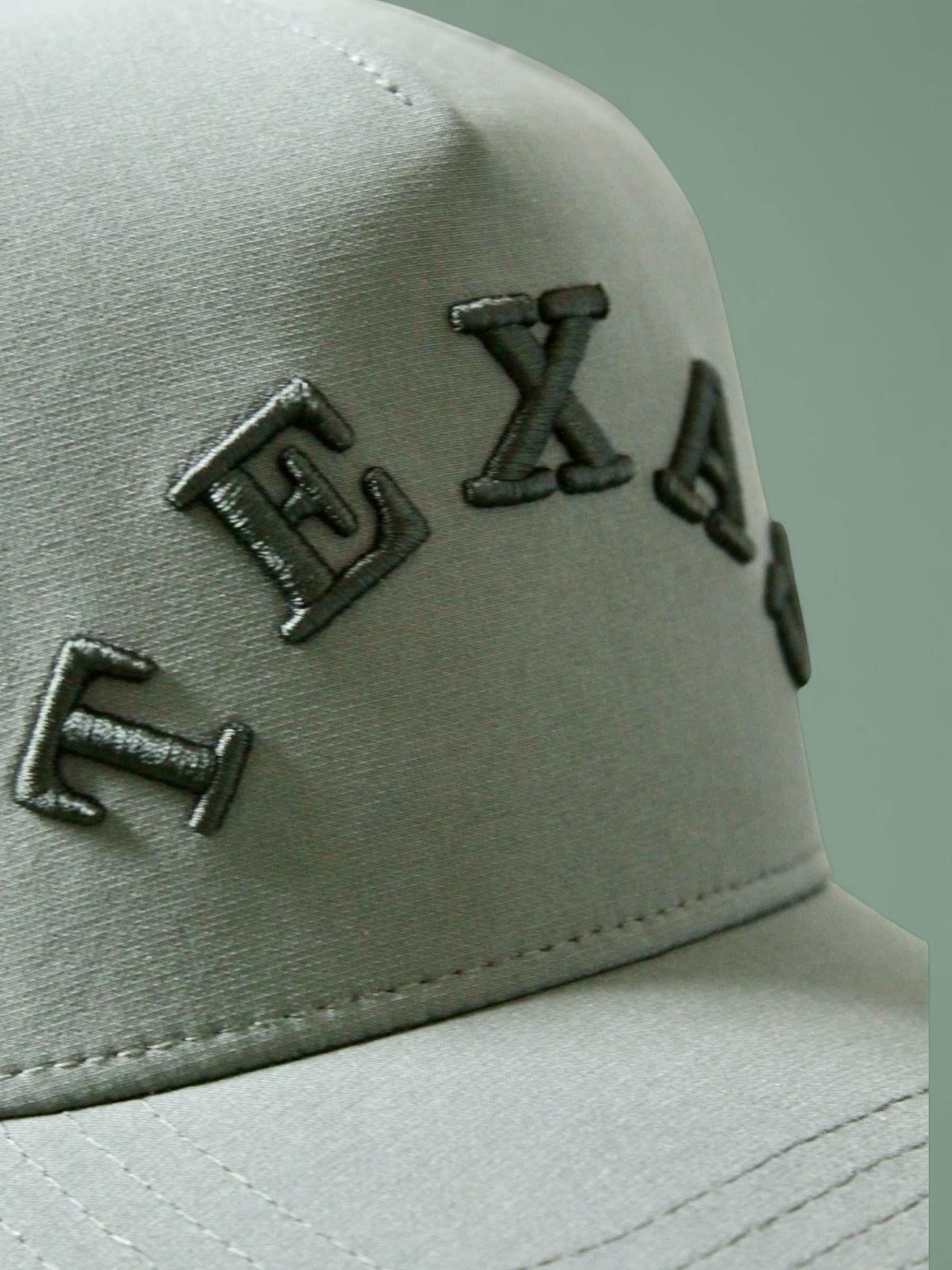 The Texas Performance Snapback olive green nylon cap with raised dark embroidered Texas lettering