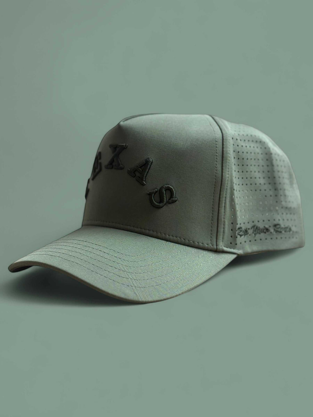 The Texas Performance Snapback olive green nylon cap with perforated side panels and raised Texas lettering