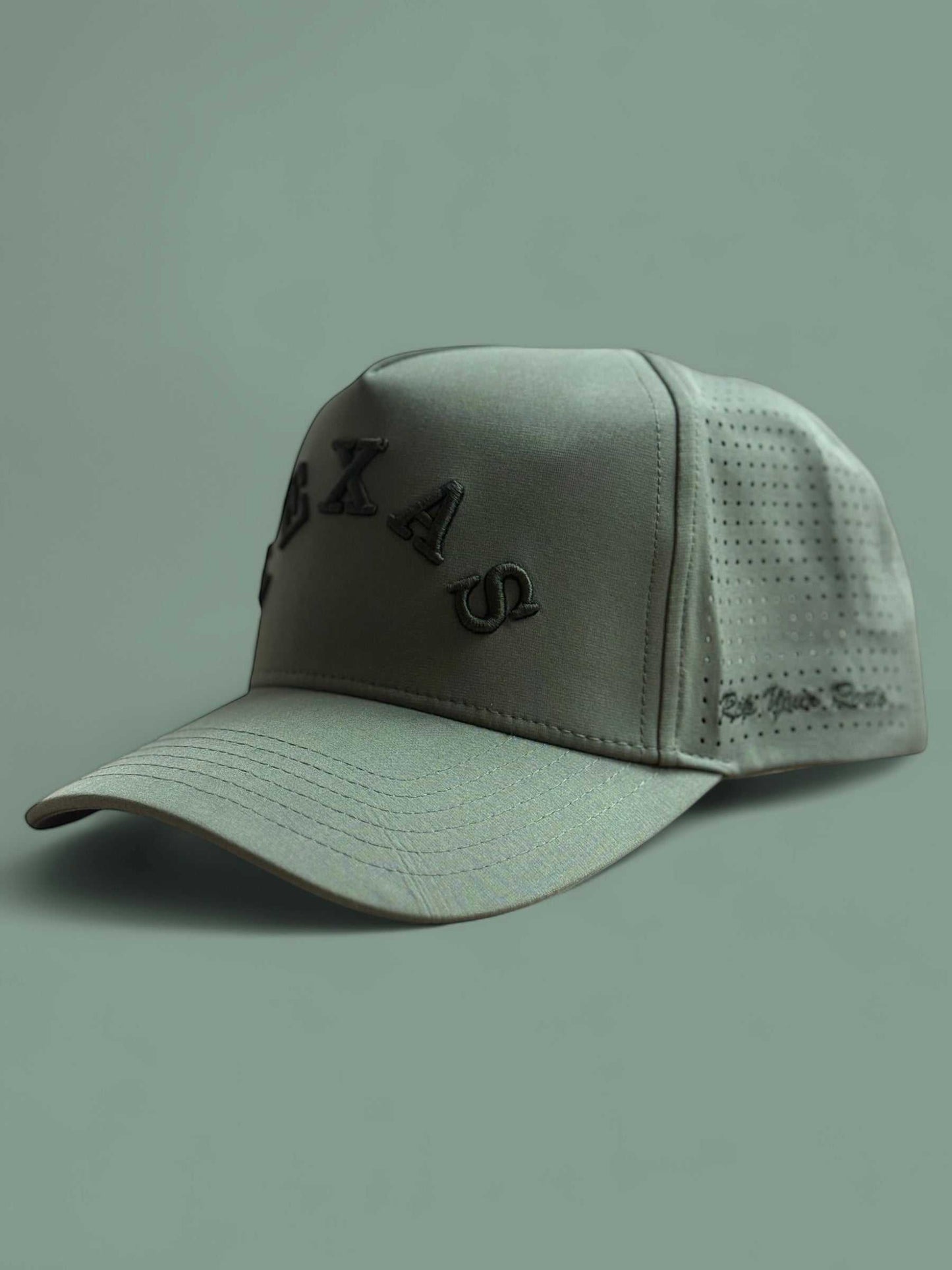 The Texas Performance Snapback olive green nylon cap with perforated side panels and raised Texas lettering