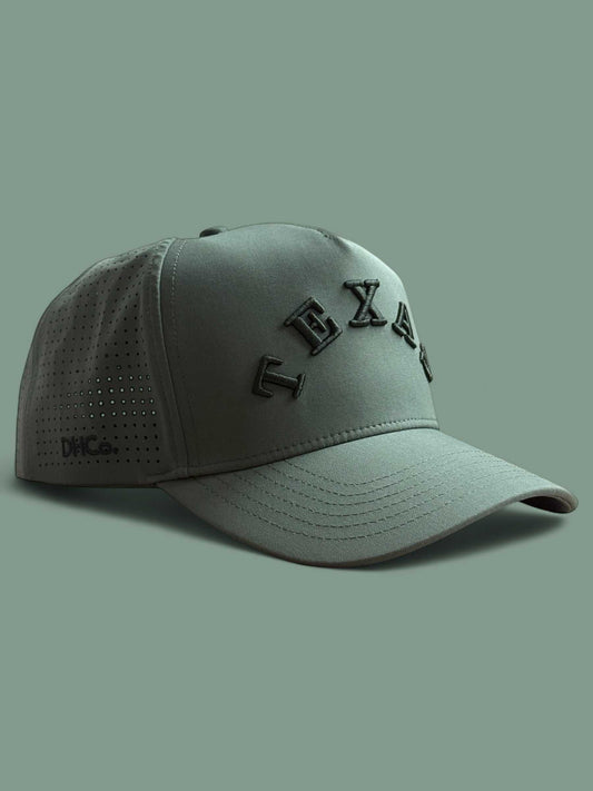 The Texas Performance Snapback, olive green nylon cap with perforated panels and raised tonal lettering
