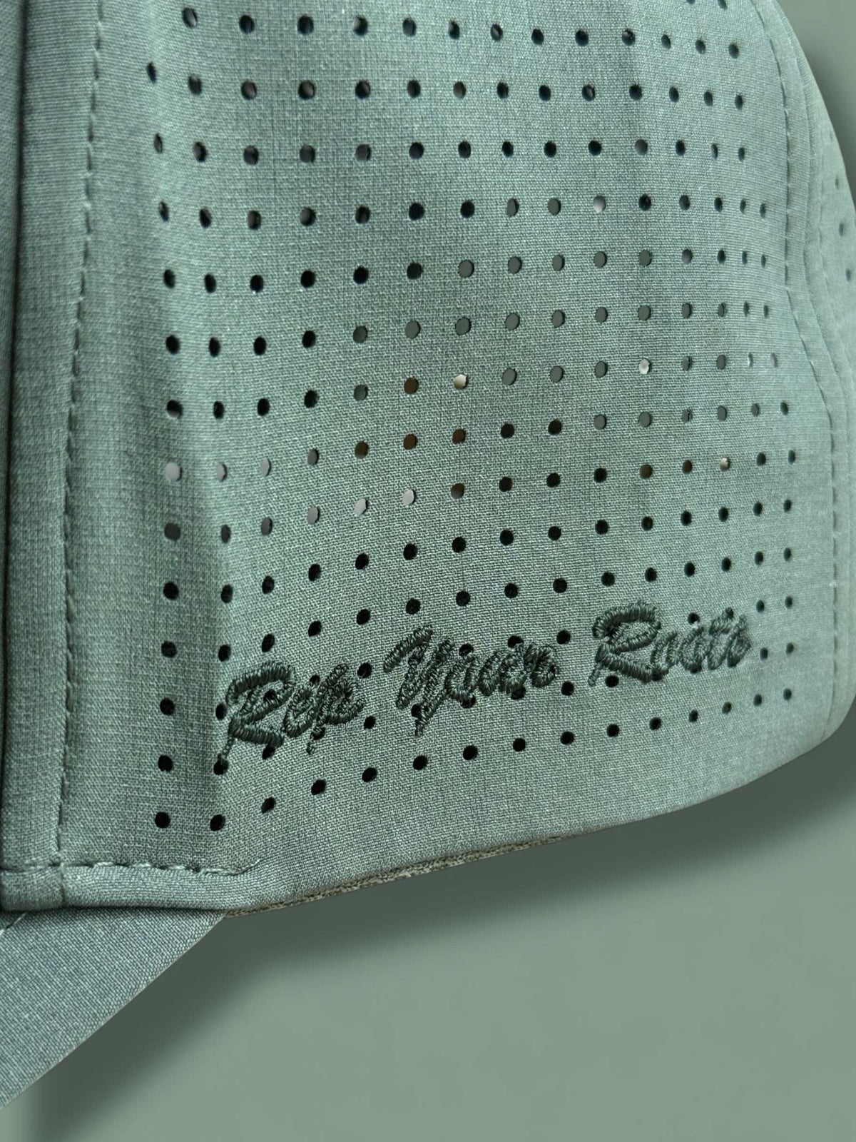 The Texas Performance Snapback olive green perforated fabric with embroidered script logo