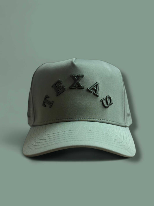 The Texas Performance Snapback olive green nylon-spandex cap with curved brim and raised TEXAS lettering