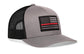 Thin Red Line Trucker Hat in grey and black mesh with an embroidered black flag patch and red stripe