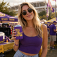 Tiger Silhouette Louisiana Can Cooler in purple with a gold tiger silhouette, held by a woman wearing purple outdoors