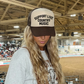 Trucker hat with white foam front and black mesh back featuring bold black Support Live Country Music text embroidered on front panel.