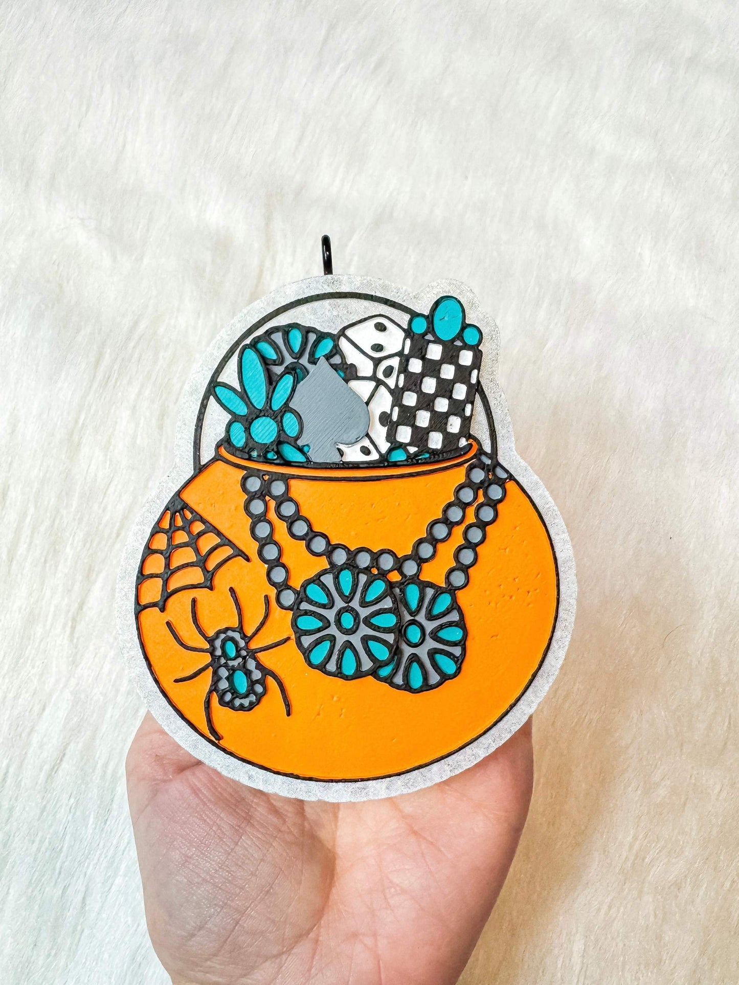 Turquoise Pumpkin Pail freshie with orange pumpkin, turquoise floral accents, spider, and black-white patterned details