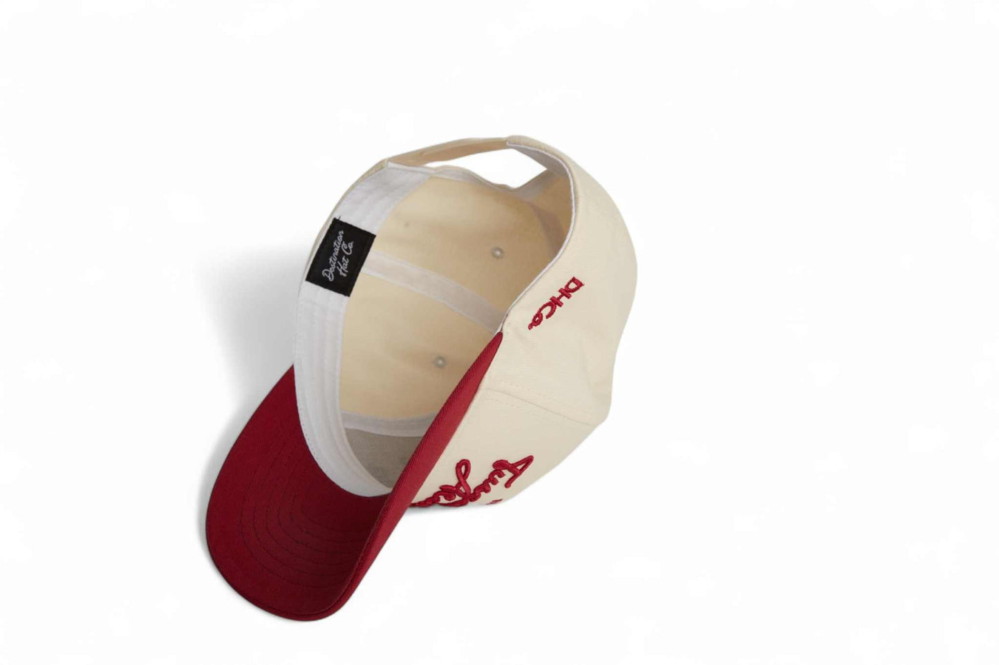 Tuscaloosa Script Hat in beige with a red pre-curved brim and embroidered script lettering