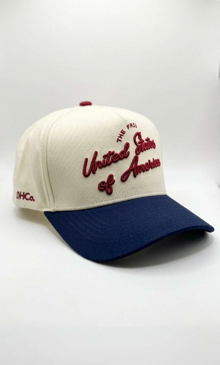 U.S.A Script Hat in cream cotton with navy pre-curved brim and raised red patriotic script embroidery
