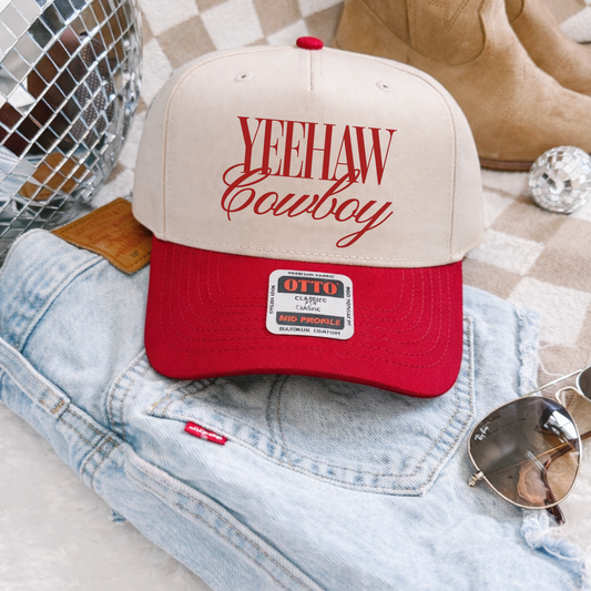 Yeehaw Cowboy Trucker Hat in cream and red, featuring bold western script and a curved brim
